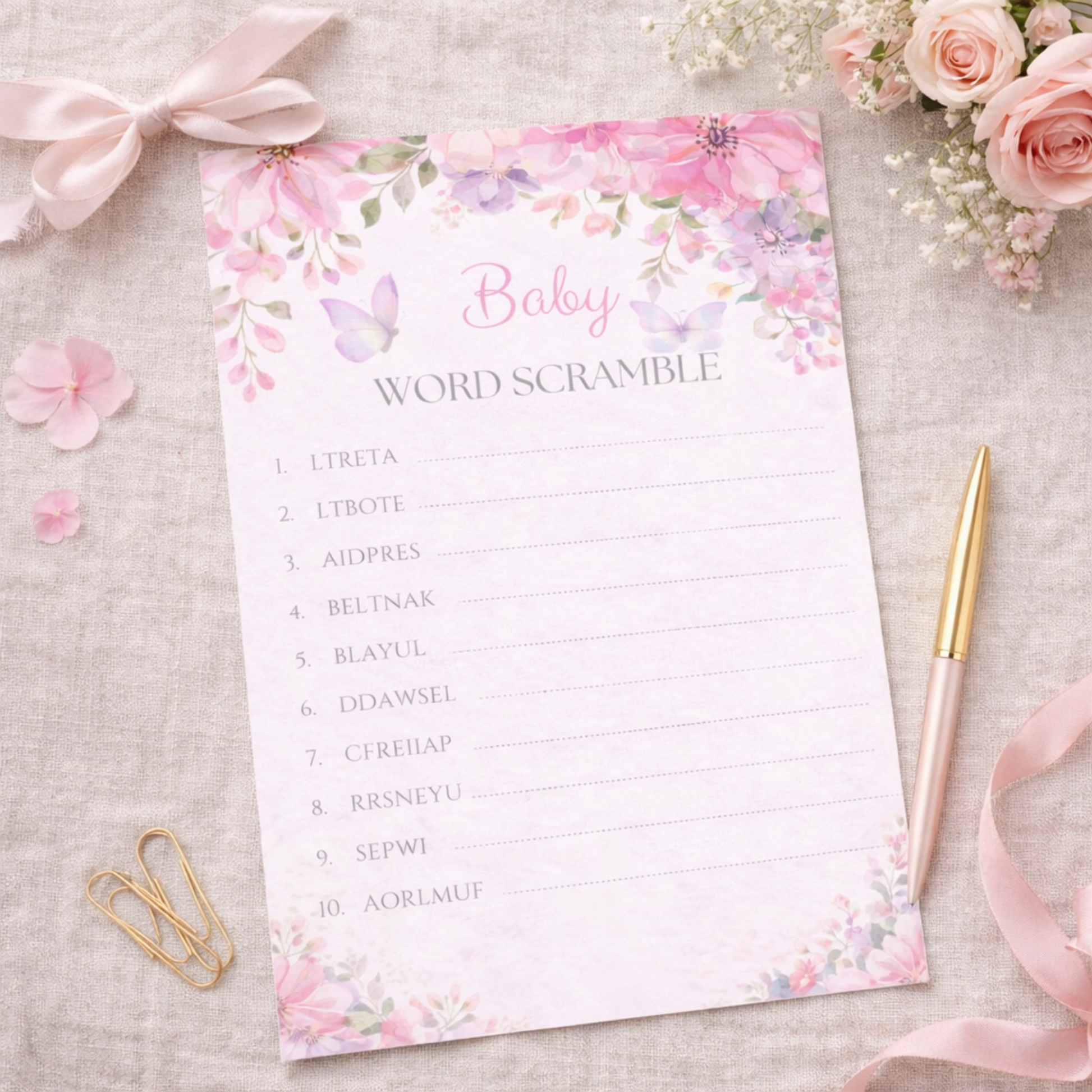 Baby word scramble game sheet with floral design on a textured surface with flowers and ribbons.