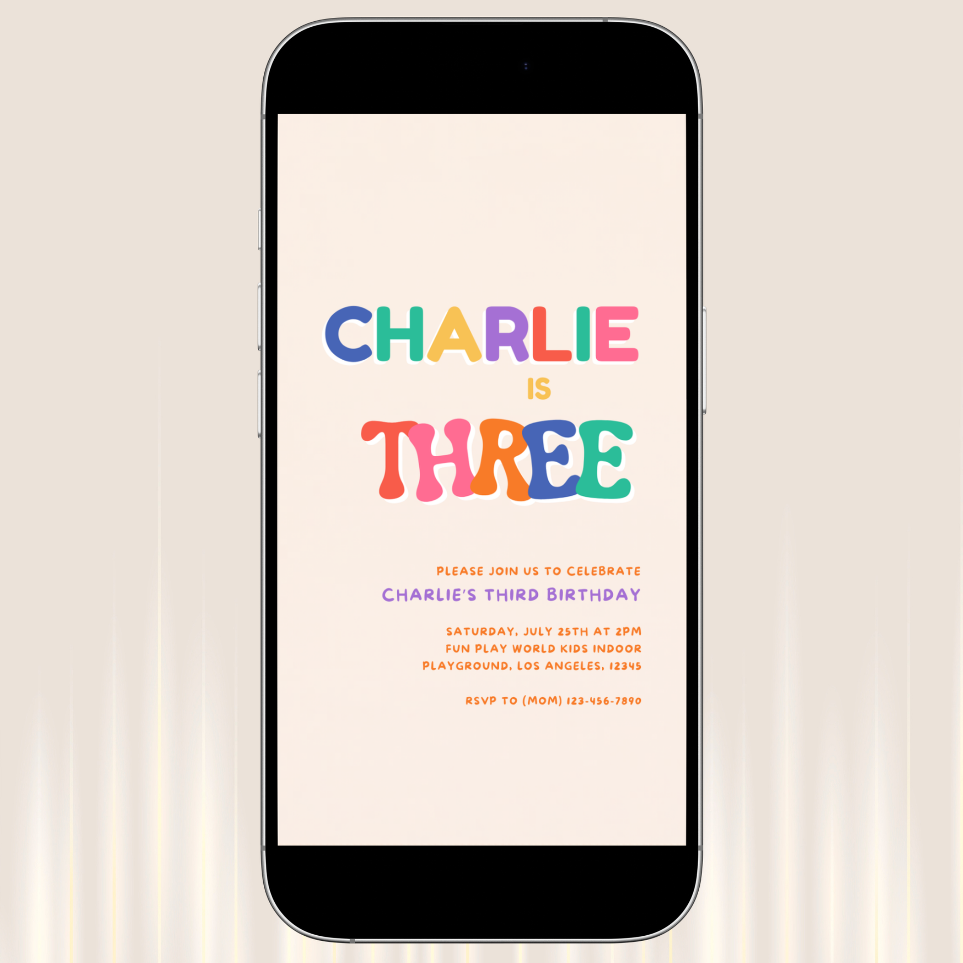 Phone displaying a colorful birthday invitation with 'Charlie is Three' on a light background