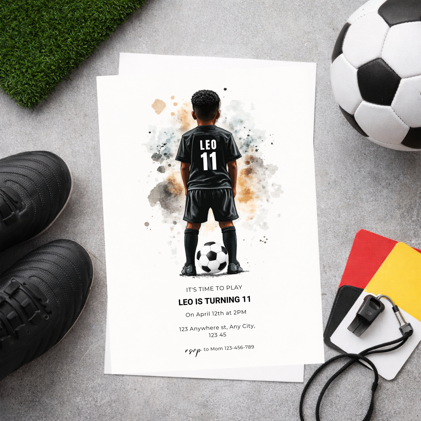 Birthday invitation card with soccer-themed design featuring a child in a soccer uniform, surrounded by soccer equipment on a gray surface.