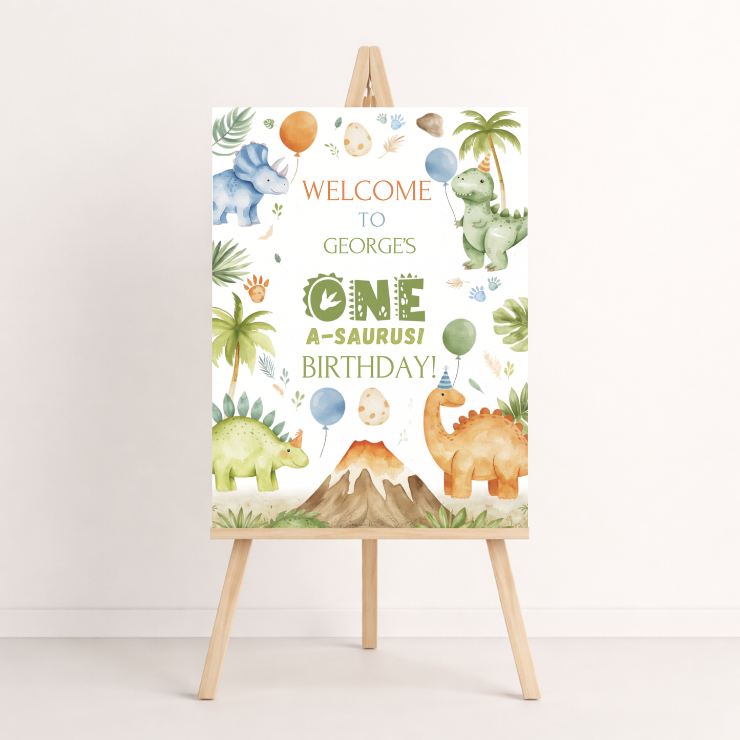 Dinosaur-themed birthday welcome sign on an easel with colorful balloons and mountain design.