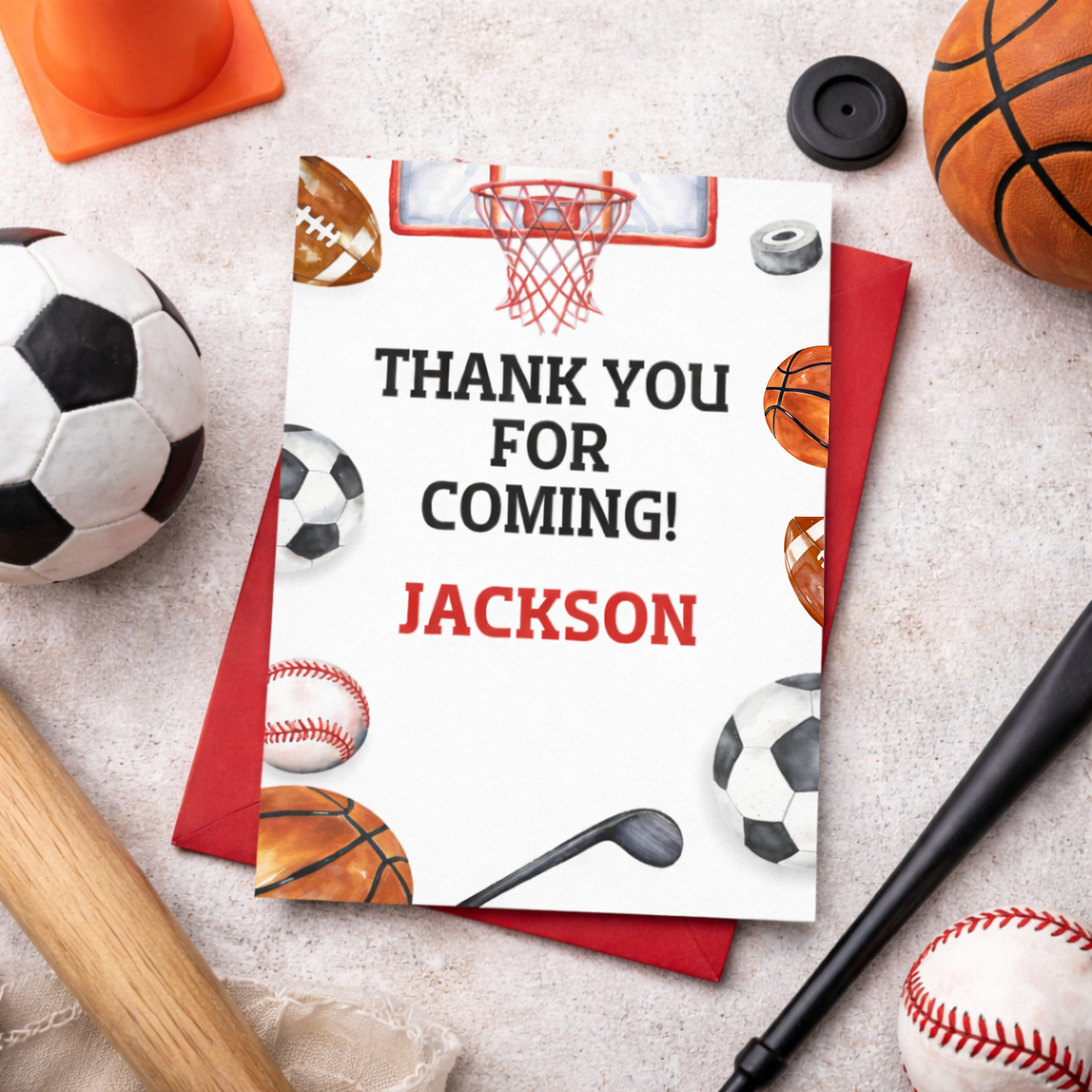 Thank you card with sports-themed design on a surface with sports equipment.