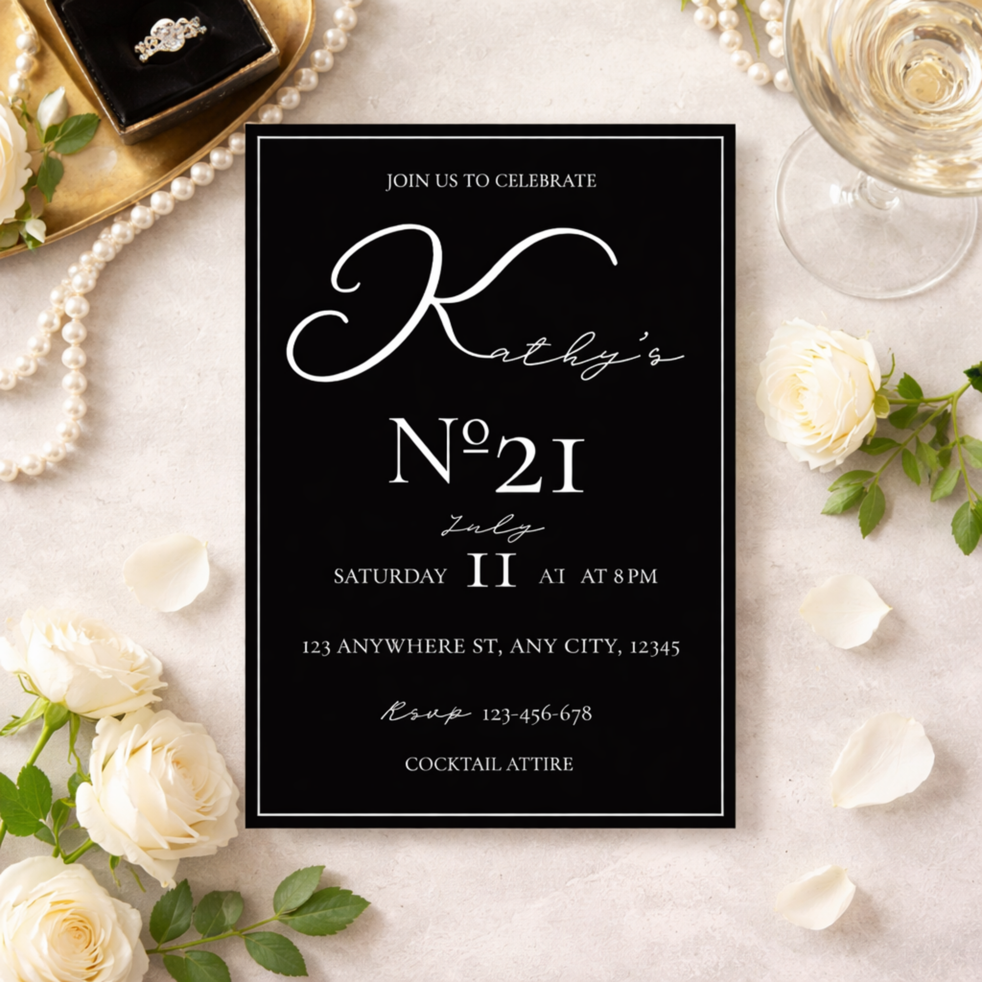 Black invitation card with white text on a decorative background with flowers and jewelry.