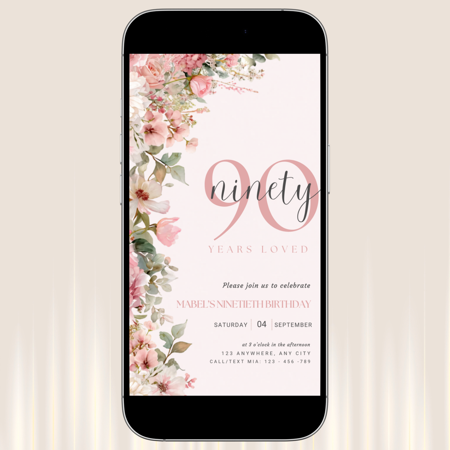 Phone displaying a floral birthday invitation with 'ninety years loved' text on a light background
