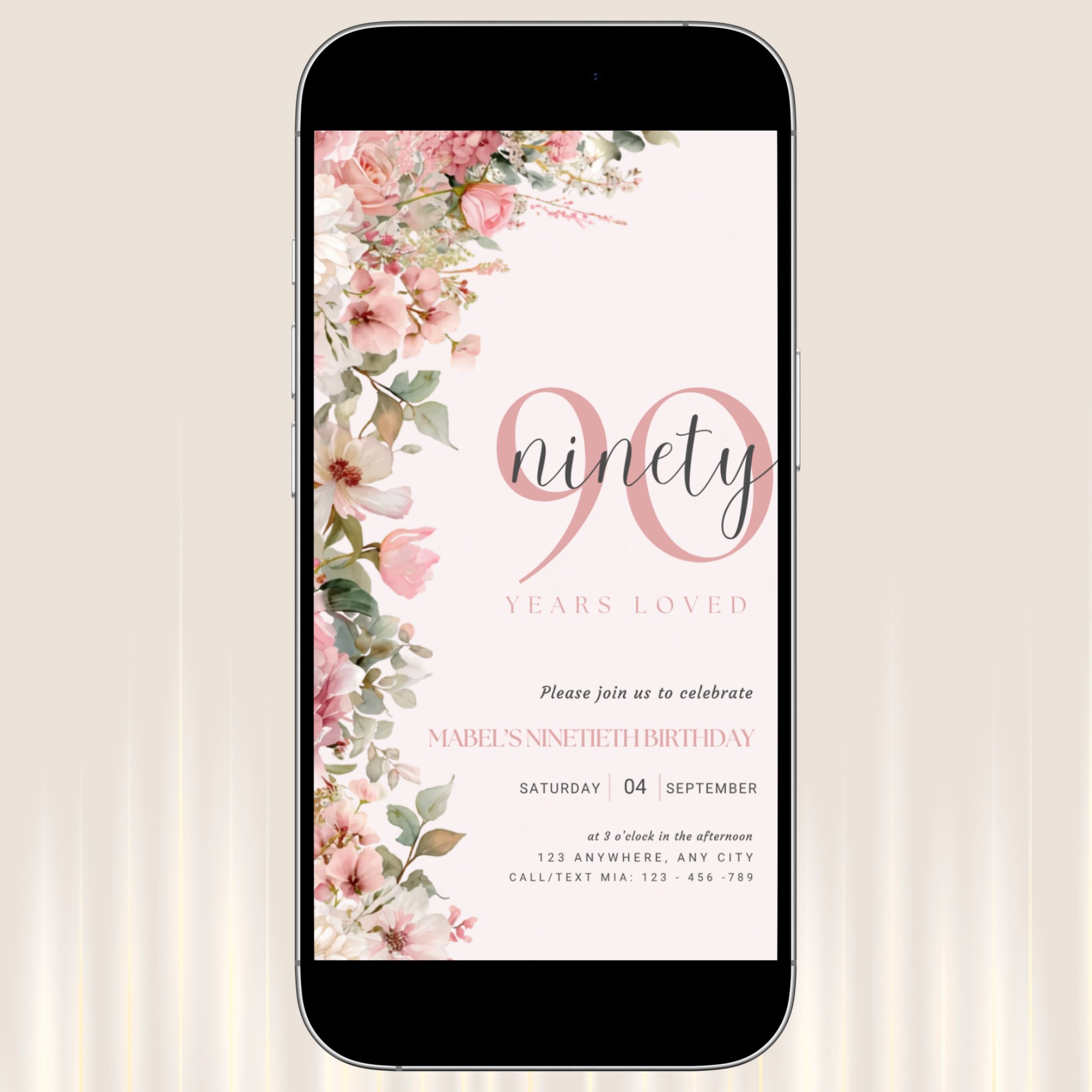 Phone displaying a floral birthday invitation with 'ninety years loved' text on a light background